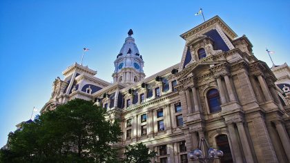 Image of Philadelphia city hall as seen from below. The sky is a deep blue.