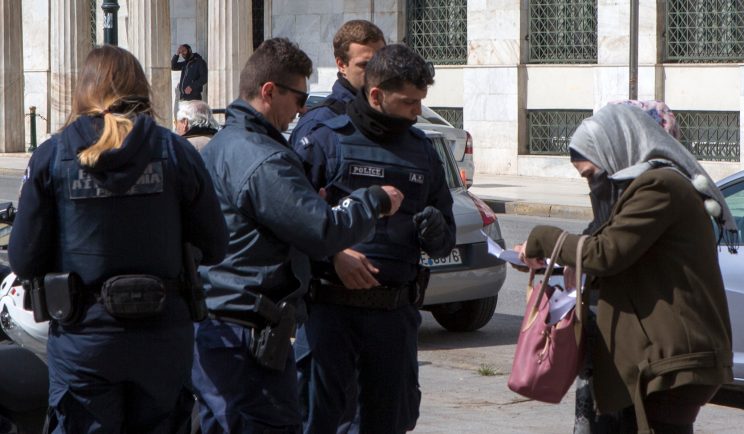 Greek police check papers of people outside during coronavirus quarantine