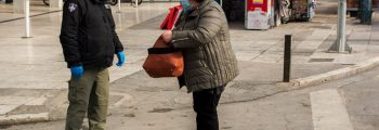 Woman has her movement papers checked in Athens, Greece