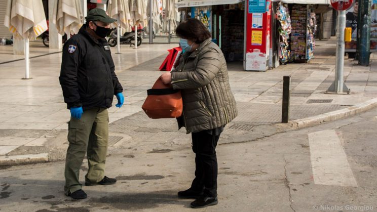 Woman has her movement papers checked in Athens, Greece
