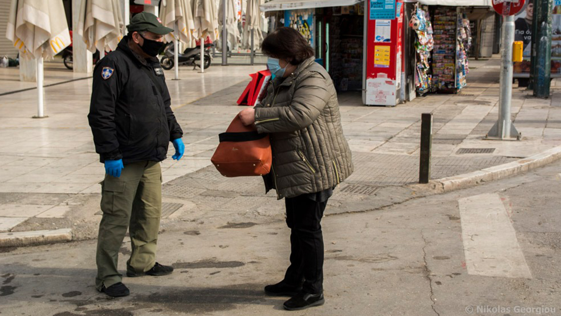 Woman has her movement papers checked in Athens, Greece