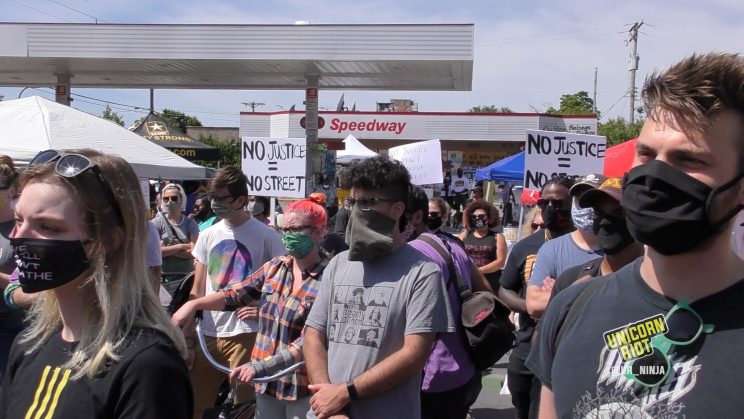 Defenders of 38th St. with No Justice No Street sign