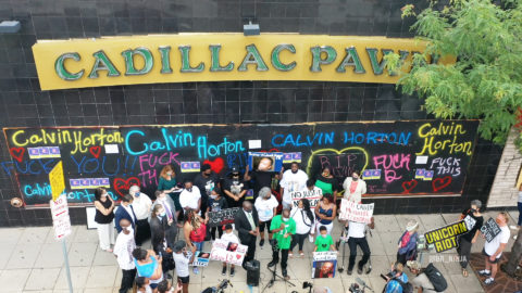 Attorney Ben Crump leads a press conference in front of Cadillac Pawn, where Calvin Horton was killed
