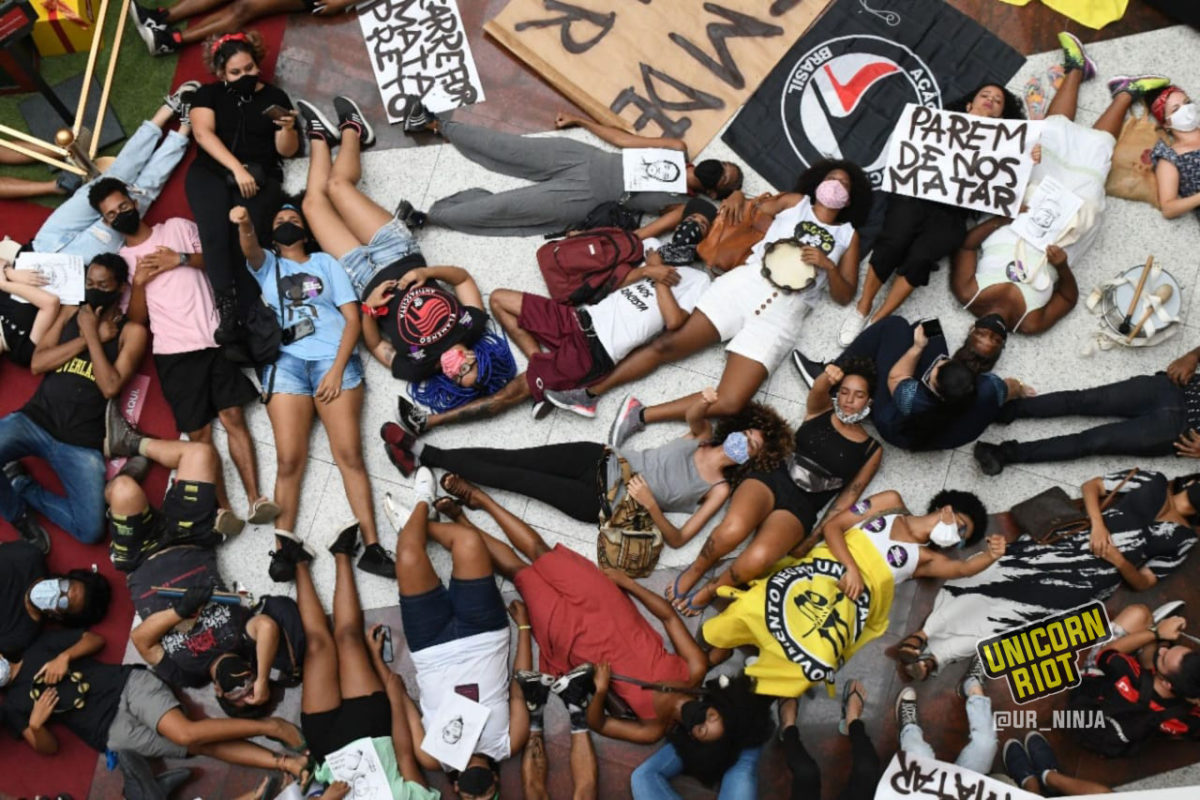 Brazilians participate in a die-in against police violence