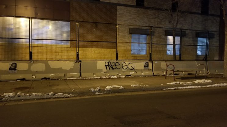 Calvin Horton's image wheatpasted on barricades in front of the 3rd Precinct