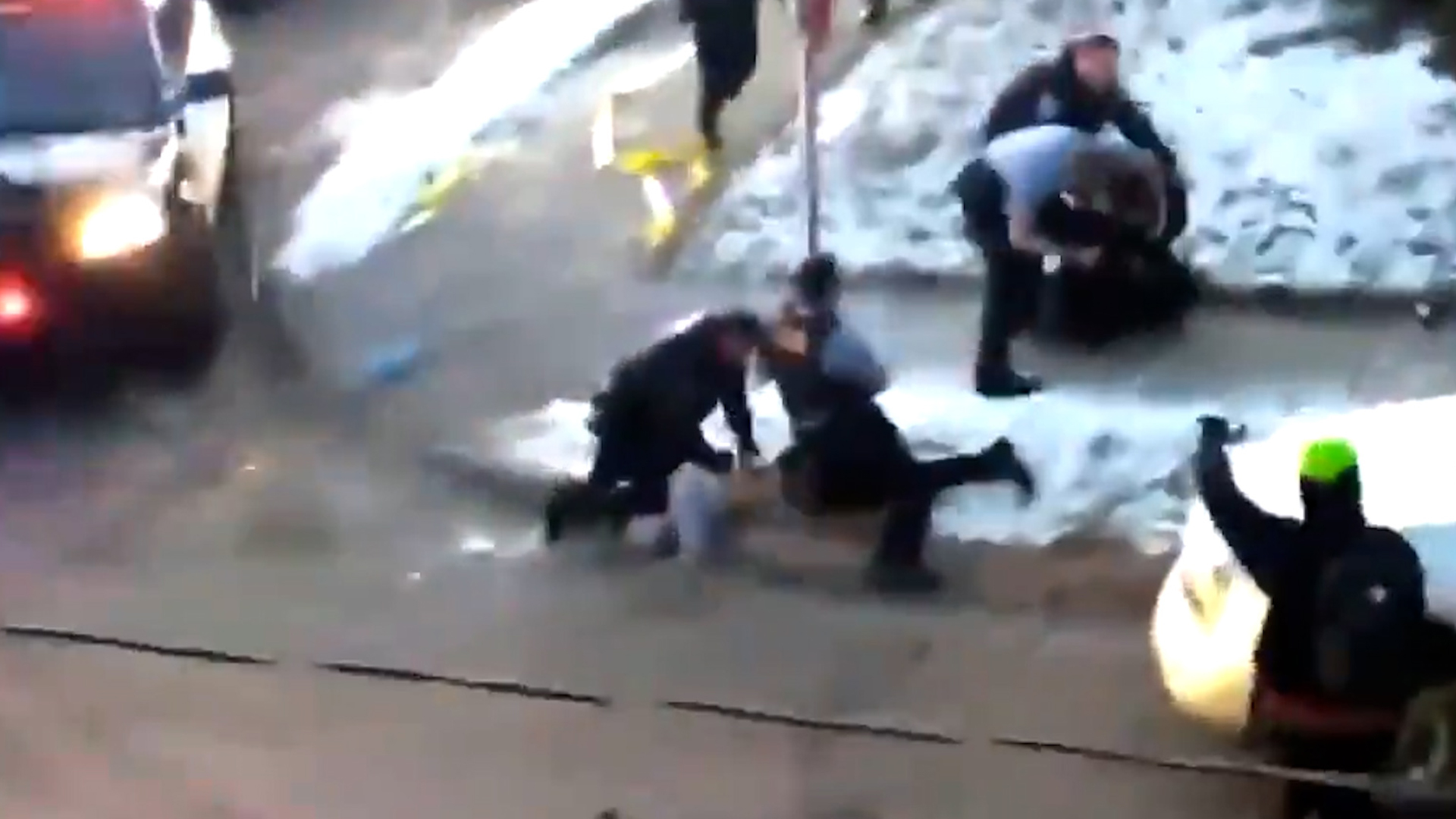 minneapolis police kneeling on a person's neck while they hang off the curb with their face into the concrete