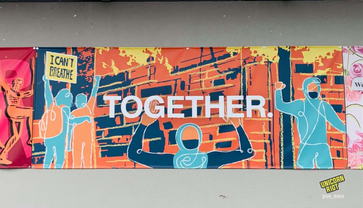 Mural features a scene of a burning building with protesters cheering, holding a sign that reads “I can’t breathe” across the street from the 3rd precinct police station which was torched by demonstrators / Photo by Marjaan Sirdar 