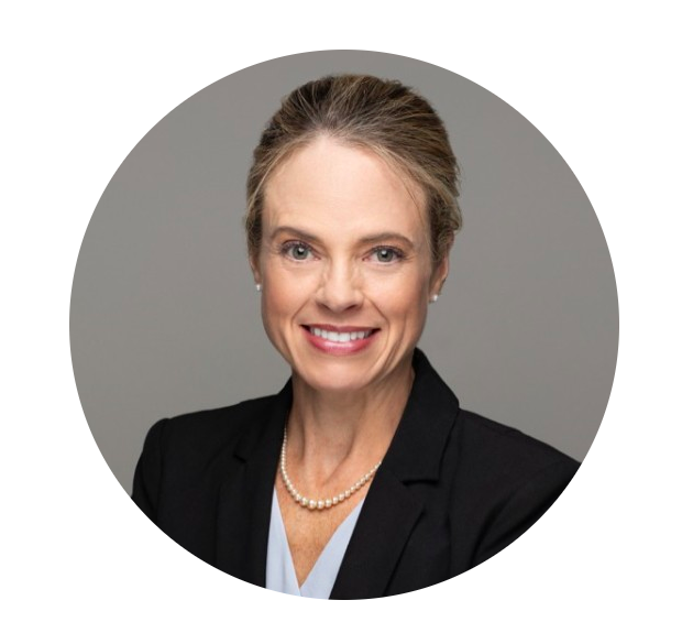 A profile headshot of former Legal Director of Training and Policy for the DeKalb County Assistant Solicitor General current DeKalb County Magistrate Judge Anna Watkins Davis. Davis is a middle aged woman with brownish blonde hair tied back in this photo, sporting pearl earrings, a pearl necklace and a black blazer over a white shirt. 
